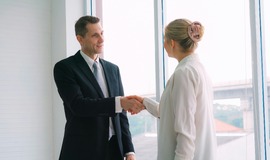 Solicitor and client hand shaking